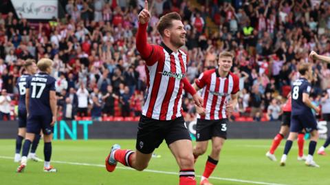 Lincoln goalscorer James Collins celebrates