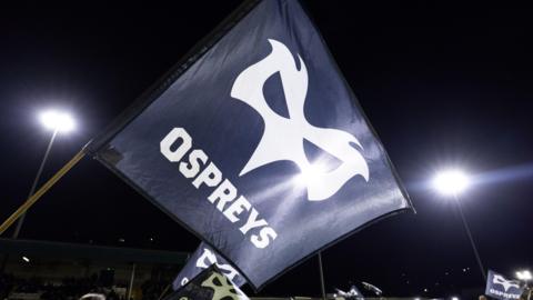 An Ospreys flag is flown at a game