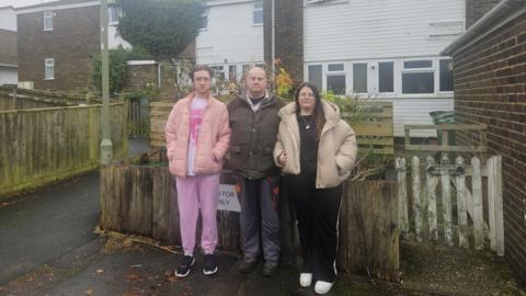 Jason Ebury stood alongside his kids outside their home