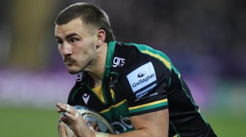 Ollie Sleightholme, carrying the ball during a game for Northampton Saints