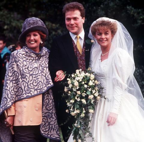 Sue and Alex Tatham on their wedding day, alongside guest Cilla Black