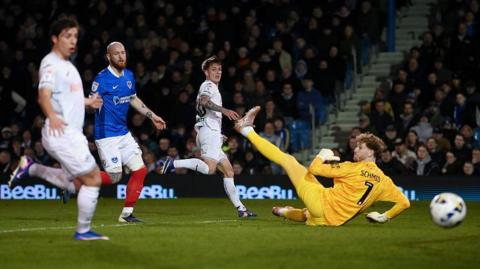 Ethan Galbraith of Swansea City misses a chance as Nicolas Schmid of Portsmouth attempts to make the save 