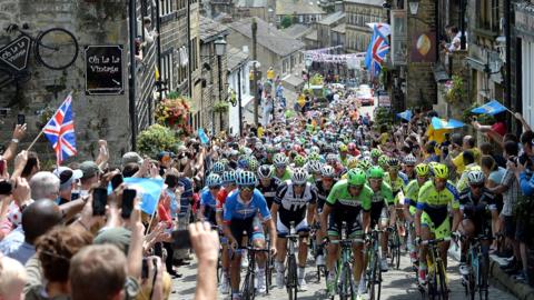 Cyclists during the the Tour de France in Yorkshire in 2014 ride uphill in Haworth.