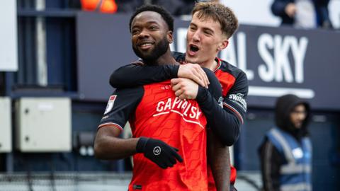 Luton's Shayden Morris is hugged by a team-mate after scoring against Bradford