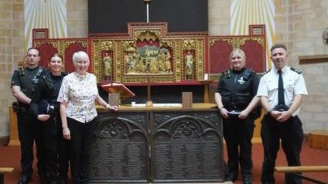 Members of Kent Police stood beside the returned military memorial plaques that were stolen from Christ Church in Luton Road, Chatham. Priest in charge the Reverend Andrea Leonard is also in the picture.