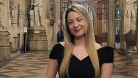 Shinead Francis she has long blonde hair and is wearing a black top.