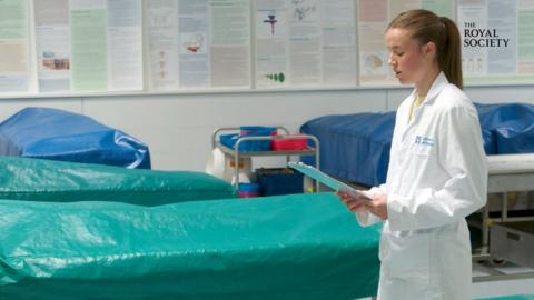 Young female medical student looking at a clipboard