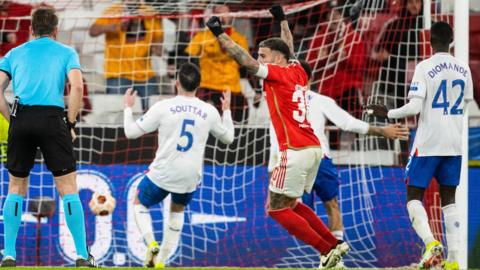 Benfica's Nicolas Otamendi celebrates after Rangers' Connor Goldson scores an own goal