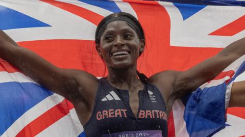 Great Britain sprinter Daryll Neita celebrates after winning 4x100m silver medal at the 2024 Paris Olympics