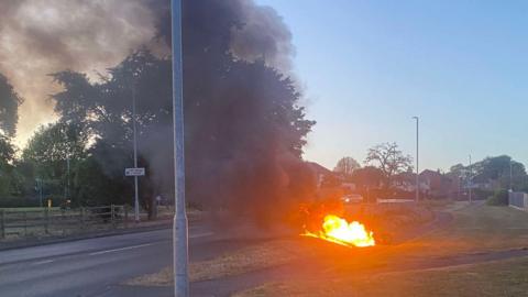 A motorcycle well alight on the side of a road