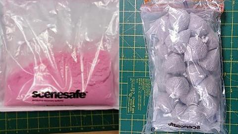 (Left) A plastic bag with the word 'scenesafe' filled with pink powder believed to be pink cocaine with a green ruler at the bottom to show scale. On the right there is a bag of pale grey rocks also in a plastic bag with the word 'scenesafe'.