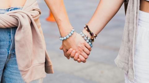 Women holding hands