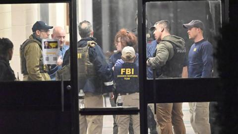 FBI officers work at the scene in Rhode Island on Saturday night