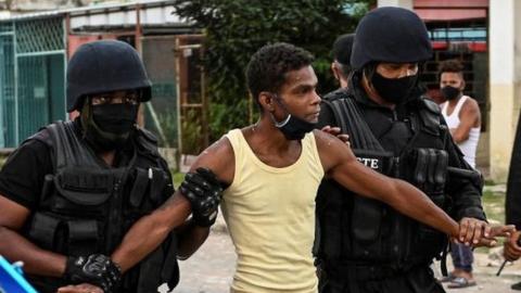 A man is arrested during a demonstration against the government of President Miguel Diaz-Canel in Arroyo Naranjo Municipality, Havana on July 12, 2021.