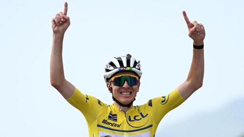 Tadej Pogacar celebrates winning on stage seven
