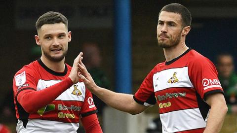 Luke Molyneux, of Doncaster Rovers, celebrates scoring with Tommy Rowe 