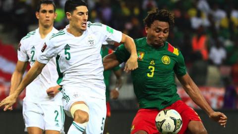 Algeria's Mehdi Tahrat (left) vies for the ball with Cameroon's Leandre Tawamba