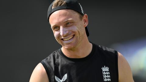 England captain Jos Buttler smiles during a training session