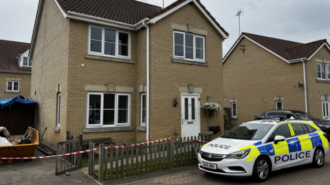 House with police car outside