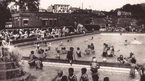 A black and white historic image of children playing in Otley Lido