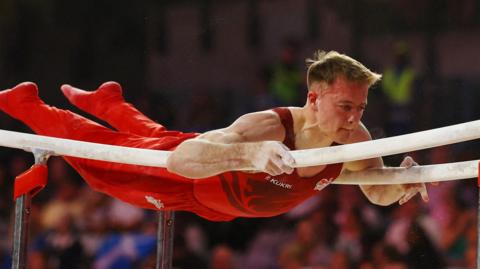 England gymmast Luke Whitehouse on the parallel bars