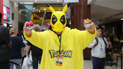 A fan dressed in a bright yellow Pikachu costume