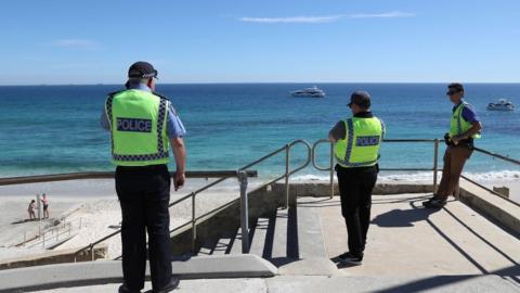 Police officers patrol Cottesloe Beach in Perth, Australia