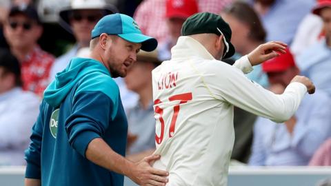 Nathan Lyon is led off the field