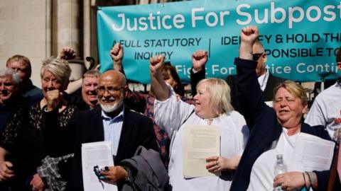 Former subpostmasters celebrate outside the Royal Courts of Justice in London