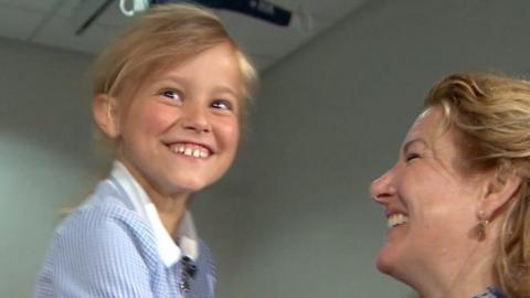 Eight-year-old Naomi with doctor