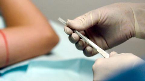 A doctor preparing to administer the contraceptive implant