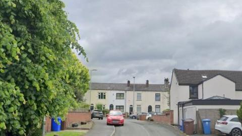 A screenshot of a street of houses from Google Street View. 