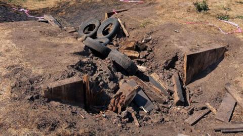 Burnt remains of play equipment made up of tyres and wooden beams at West Park in Kirkby  in Ashfield