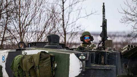 A Finnish soldier of the Finnish-Swedish Division rides the Leopard 2A6 battle tank, during a demonstration of border crossing by Swedish and Finnish troops as part of the NATO Nordic Response 24 military exercise 