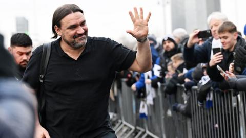 Leeds manager Daniel Farke waves to the crowd as he arrives at a game