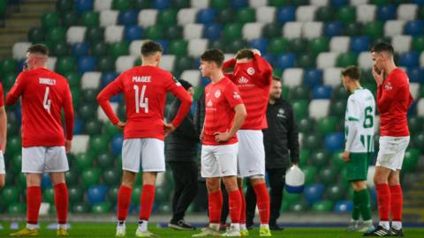 Larne players dejected at the final whistle