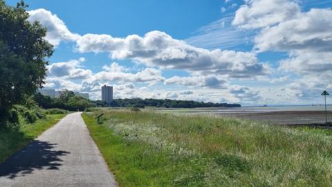 TUESDAY - The view down Weston Shore in Southampton with a path through the grass next to the water