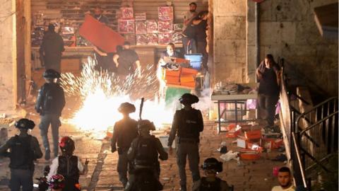Israeli police, Palestinians and a stun grenade exploding