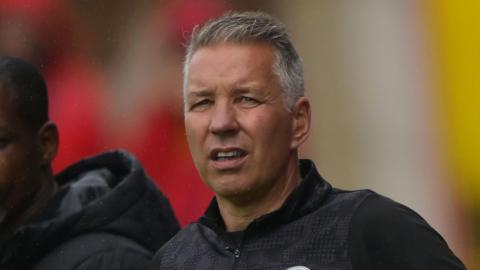 Darren Ferguson watching with a worried look on his face as Peterborough lose to Exeter on 30 August