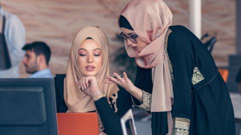 Two hijab-wearing women holding a discussion (stock image)