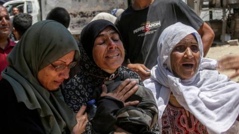 Three Palestinian women crying.