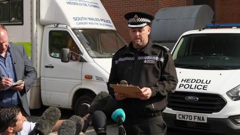 Reporters at a police press conference