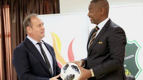 Mario Marinica and FA Malawi boss Walter Nyamilandu