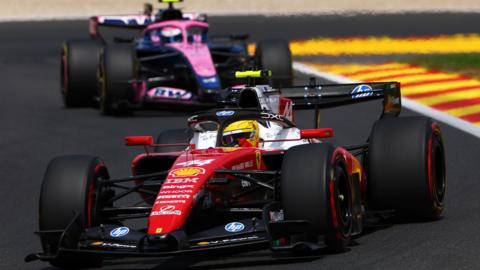 Ferrari's Lewis Hamilton with an Alpine behind him during Belgian Grand Prix final practice