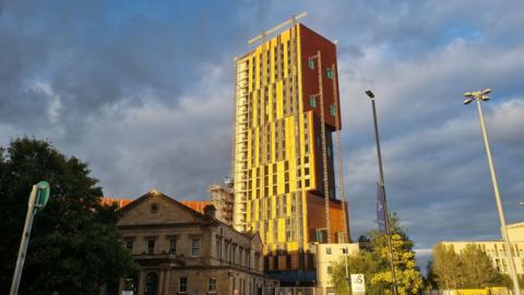 The 23-storey Broadcasting Tower has had its cladding removed.