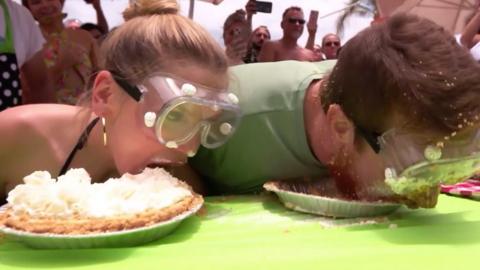 Man and woman in pie eating contest
