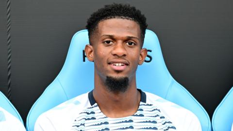 Justin Obikwu looks on from the bench 