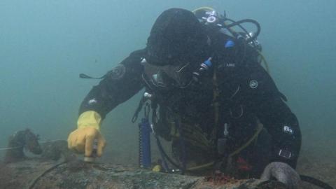 Diver marking wreck