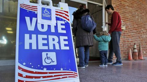 A sign stands outside a US polling place.