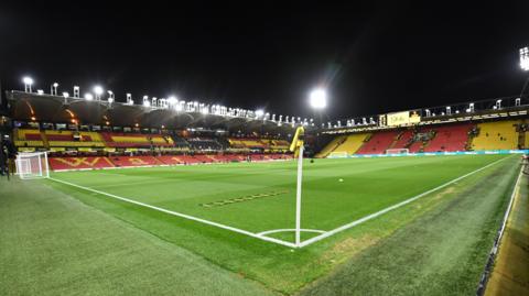 Watford's Vicarage Road stadium with the floodlights on 